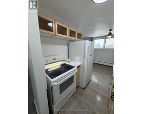 A kitchen with a white oven and refrigerator.