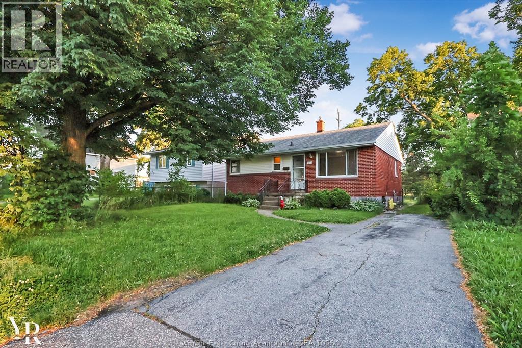 A house with a driveway in front of it.