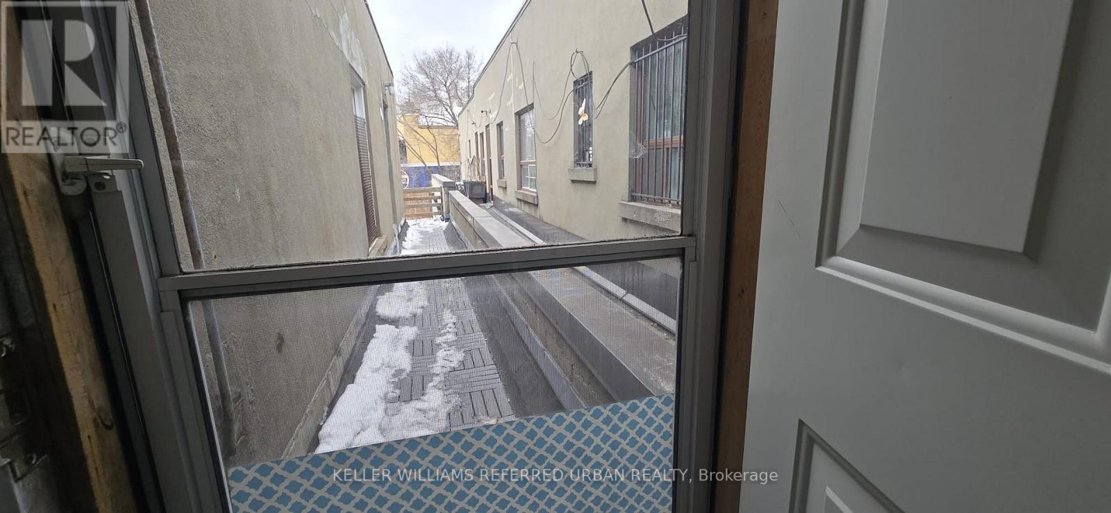 A view from inside a building looking out onto a snowy street.