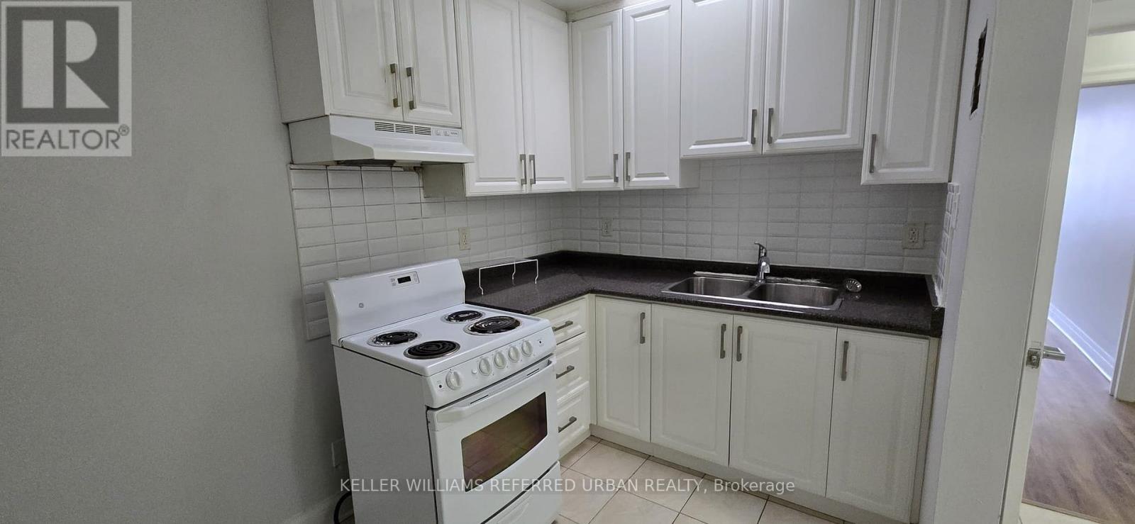 A white stove and sink in a kitchen.