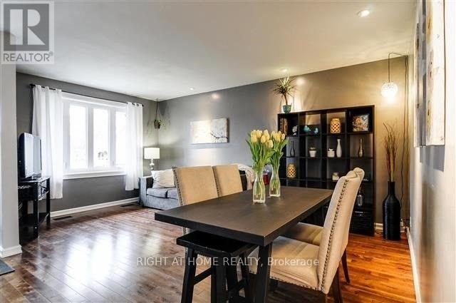 A dining room with a table set for two and a piano.