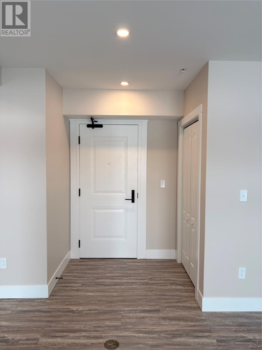A white door is in the middle of a hallway.