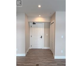 A white door is in the middle of a hallway.