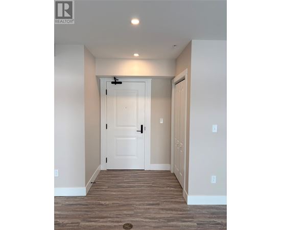 A white door is in the middle of a hallway.