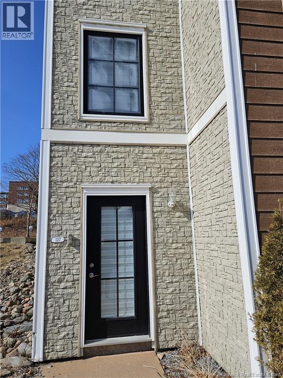A stone house with a black door and a window.