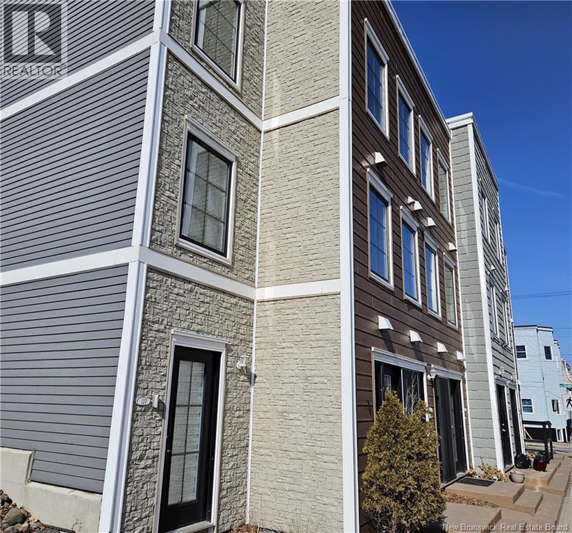 A building with a grey facade and a sign that says REALTOR.