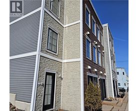 A building with a grey facade and a sign that says REALTOR.