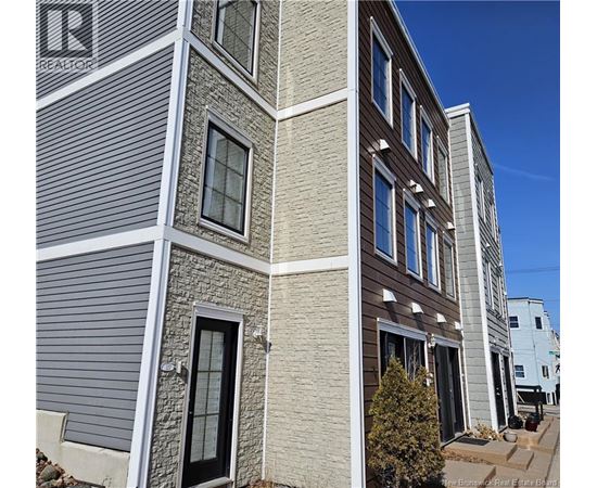 A building with a grey facade and a sign that says REALTOR.