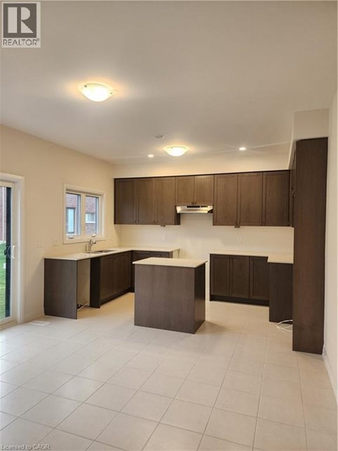 A kitchen with brown cabinets and a white countertop.