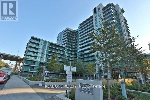 A modern building with the sign REAL ONE REALTY INC. Brokerage in front of it.