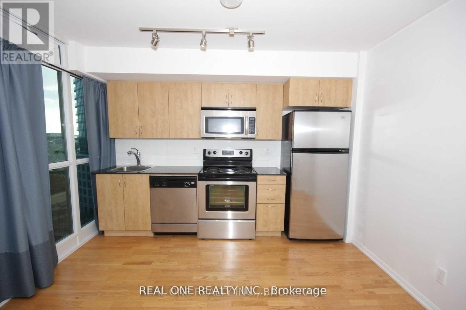 A kitchen with wooden cabinets and stainless steel appliances.