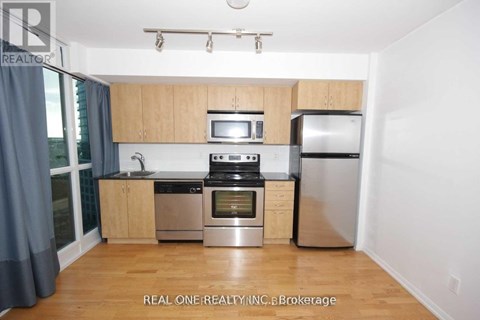 A kitchen with wooden cabinets and stainless steel appliances.