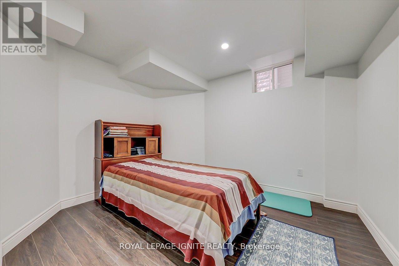 A bedroom with a bed and a wooden headboard.