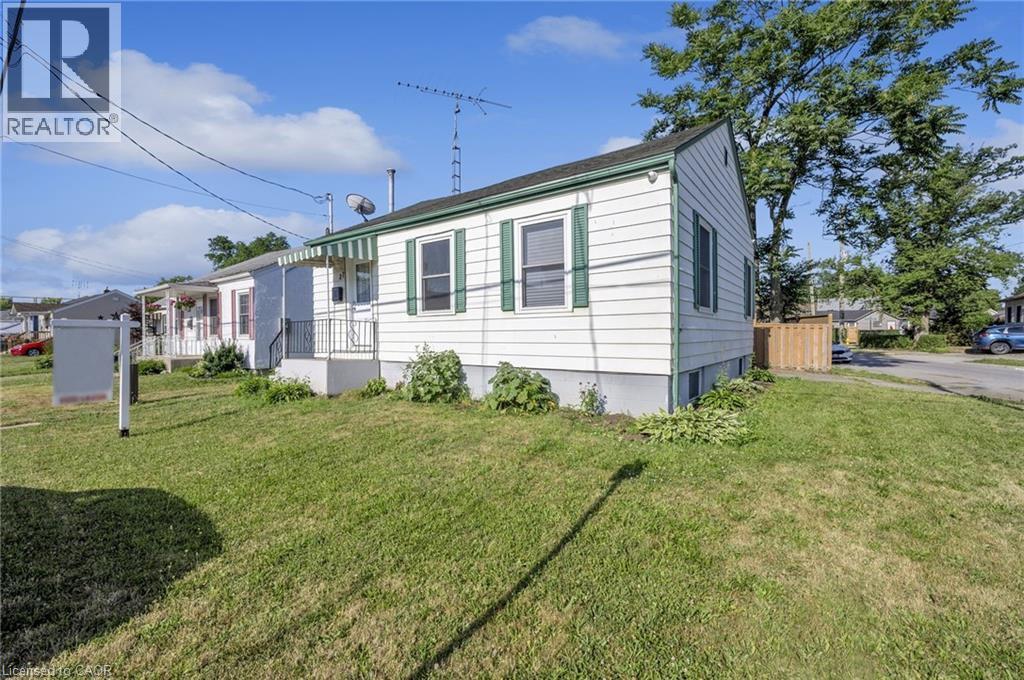 A mobile home with a green lawn in front.