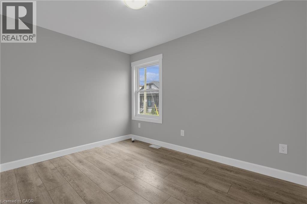 A room with a window showing a building outside.