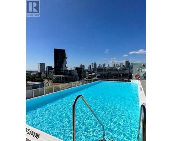 A swimming pool with a view of the city skyline.