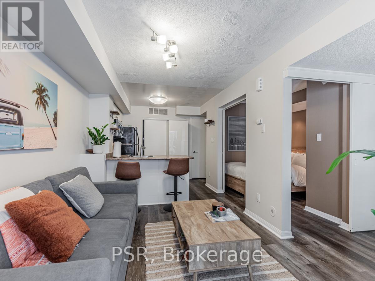 A living room with a grey couch and a wooden coffee table.