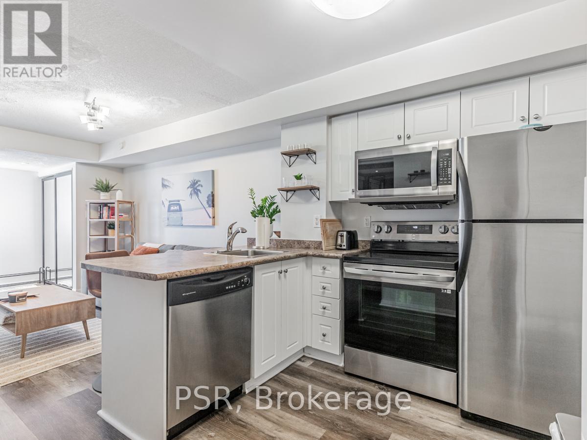 A modern kitchen with stainless steel appliances and white cabinetry.