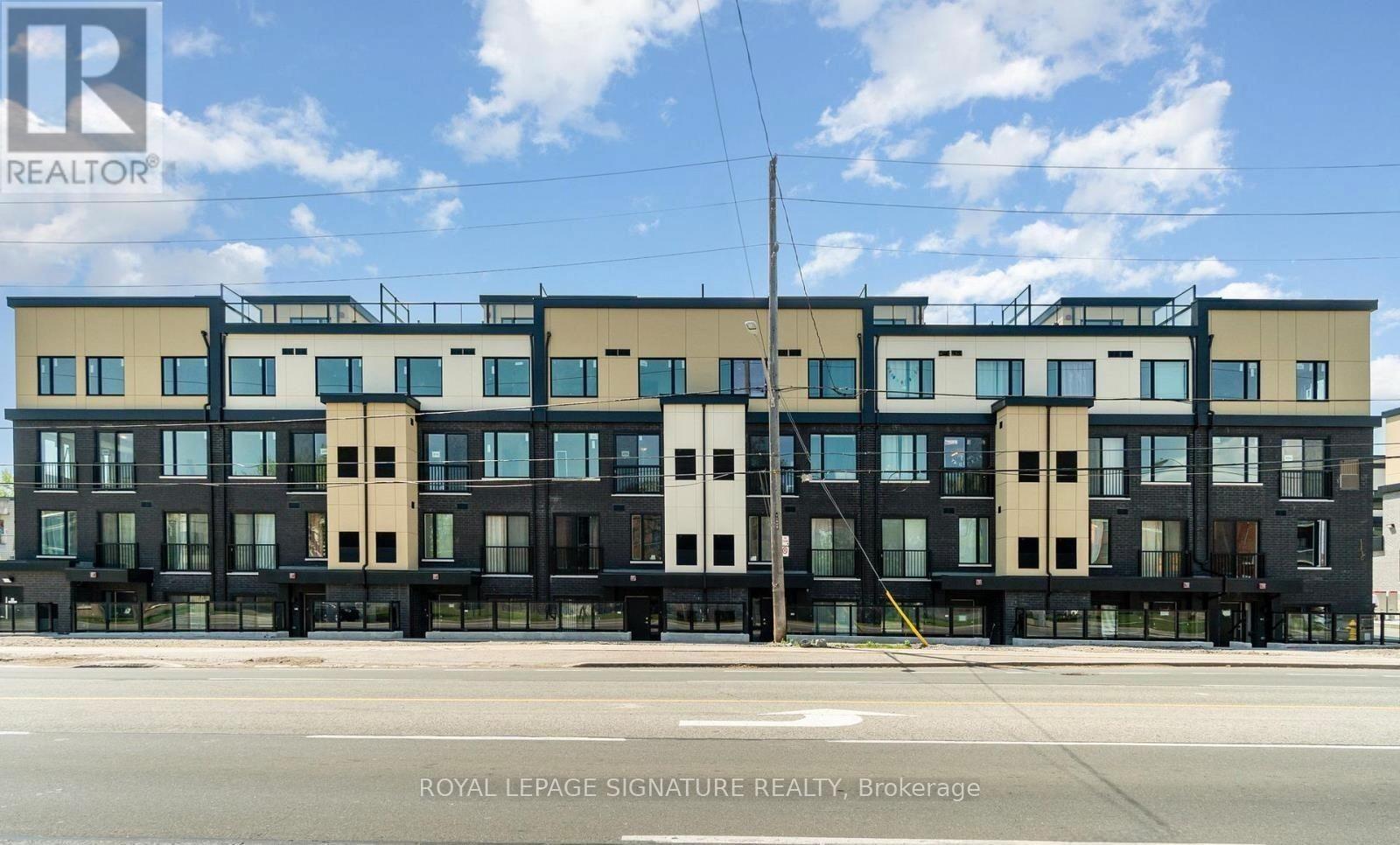 A multi-story building with a sign that reads "REALTOR" on the top left corner.