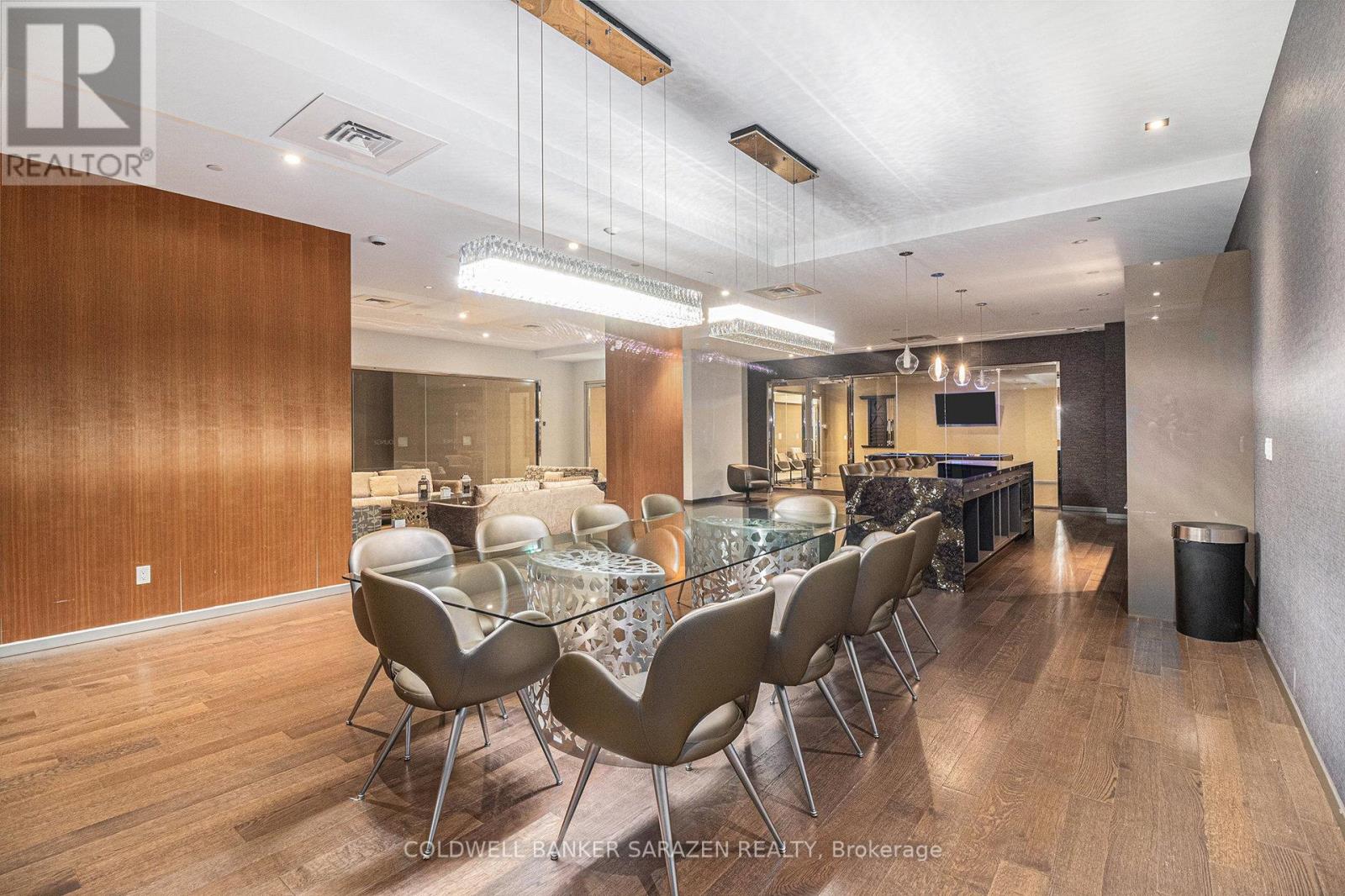 A dining room with a glass table and chairs.