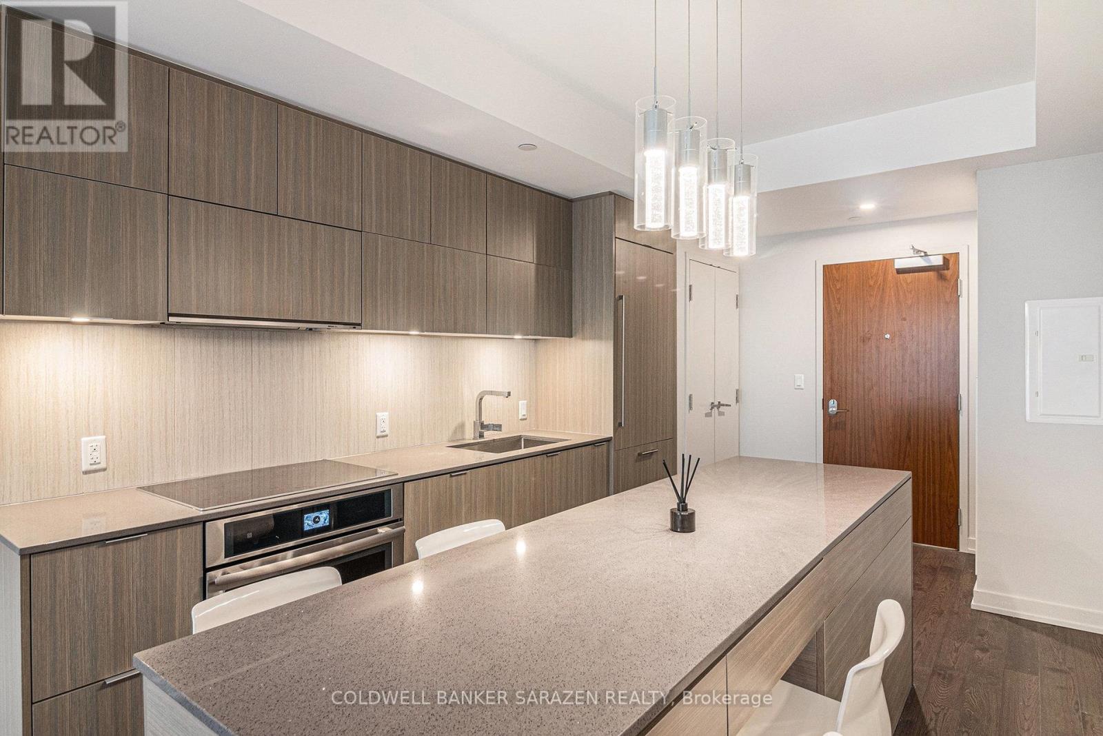 A modern kitchen with wooden cabinets and a granite countertop.