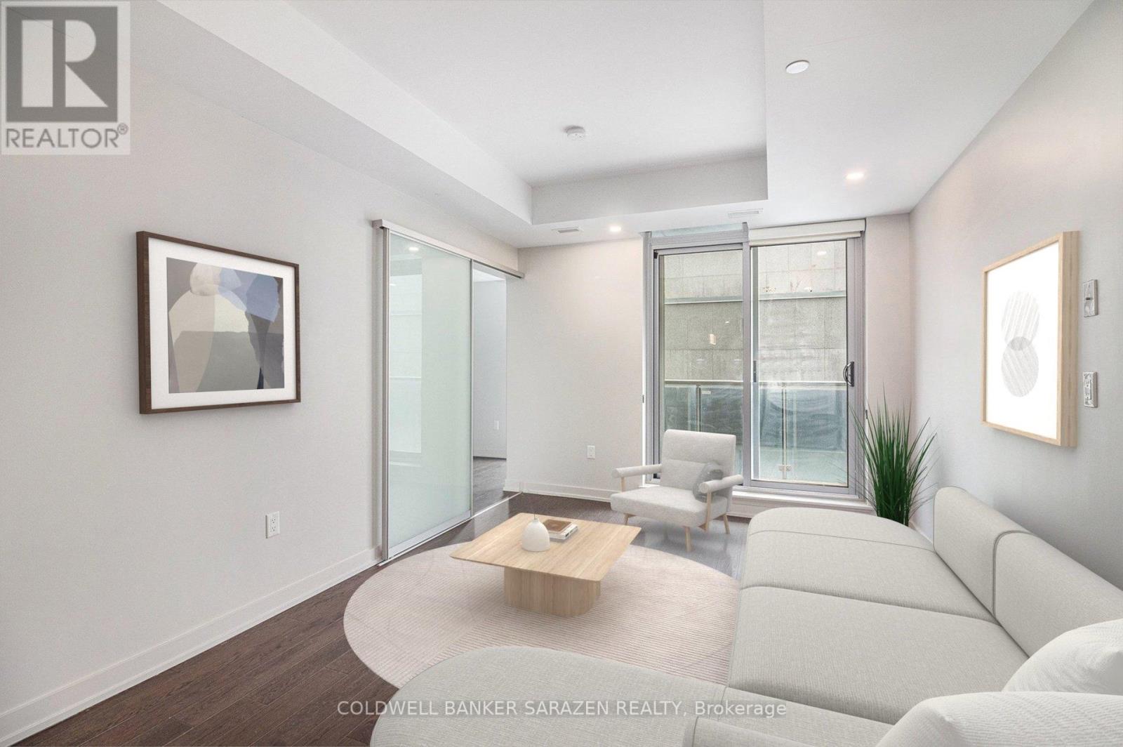 A living room with a white couch and a coffee table.