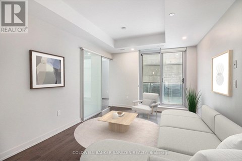 A living room with a white couch and a coffee table.