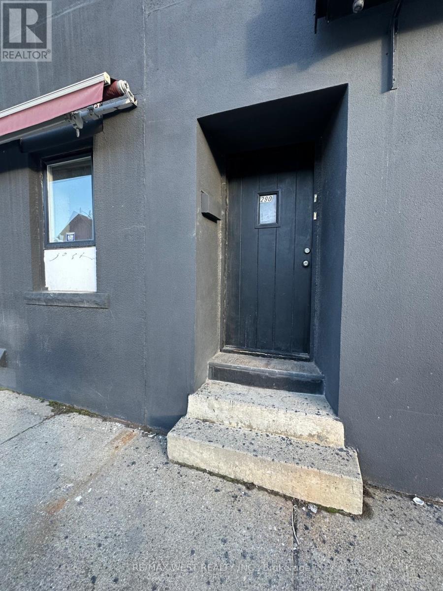 A black door with a small window above it.