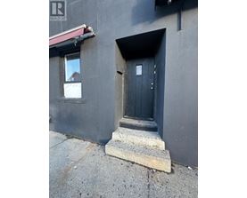 A black door with a small window above it.