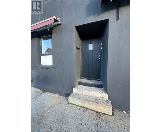 A black door with a small window above it.