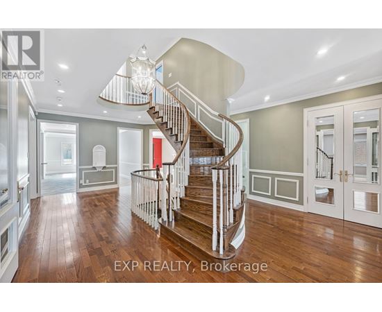 A large, well-lit, and spacious home interior with a curved staircase.