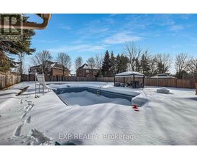 A snow-covered backyard with a pool and a slide.