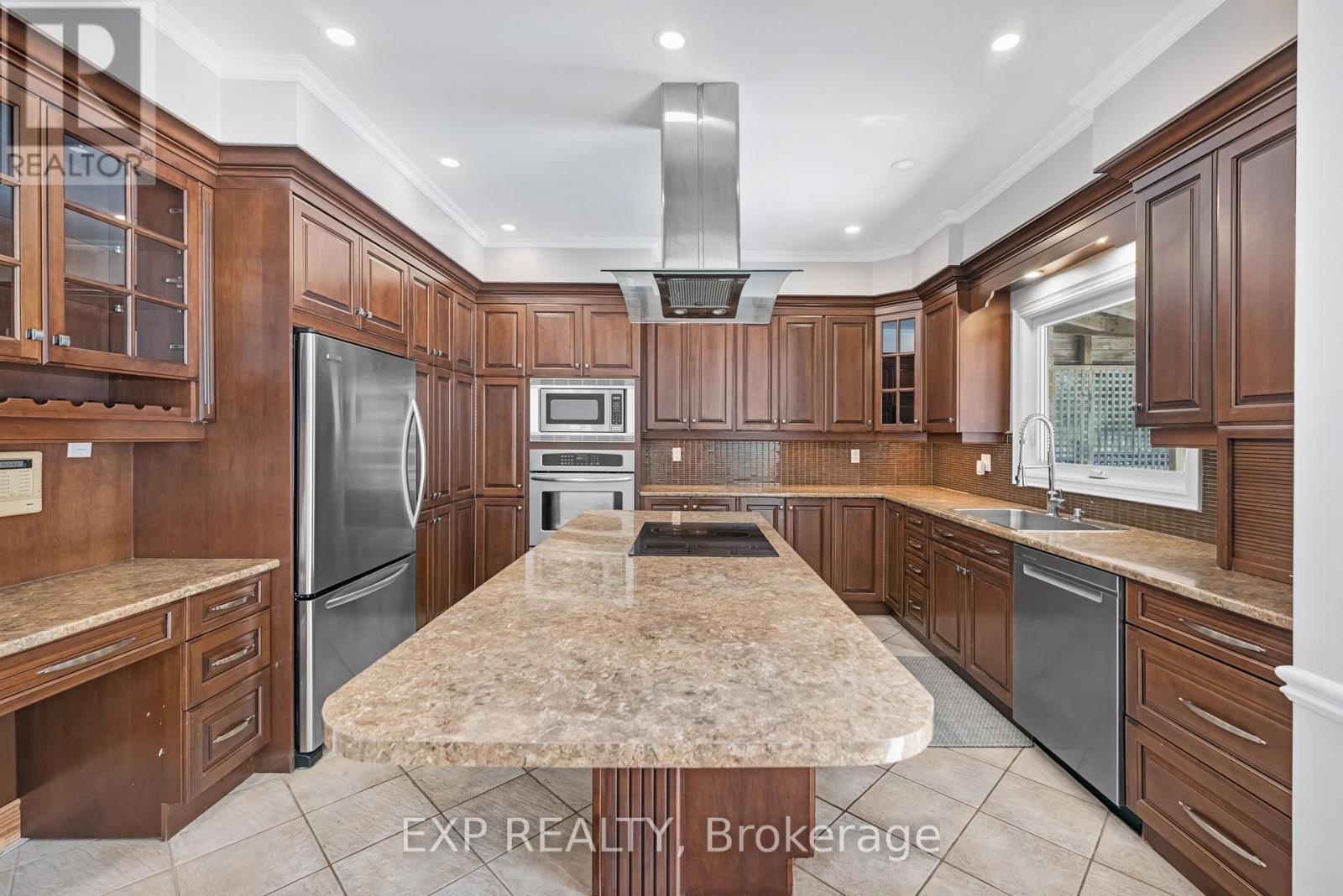 A kitchen with wooden cabinets and a marble countertop.