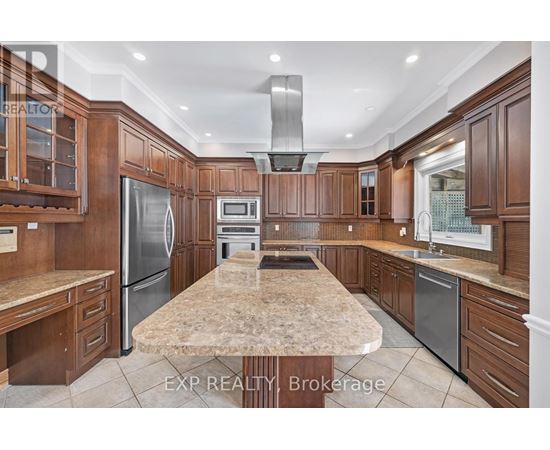 A kitchen with wooden cabinets and a marble countertop.