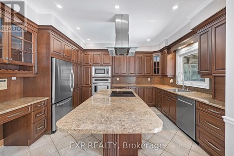 A kitchen with wooden cabinets and a marble countertop.