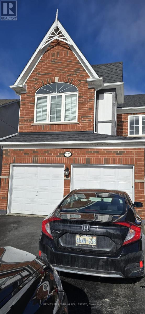 A black Honda Civic is parked in front of a brick house with a white garage door.