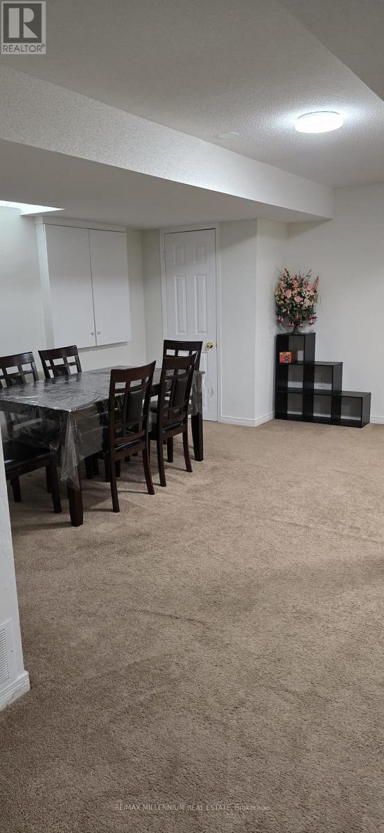 A dining room with a table and chairs.