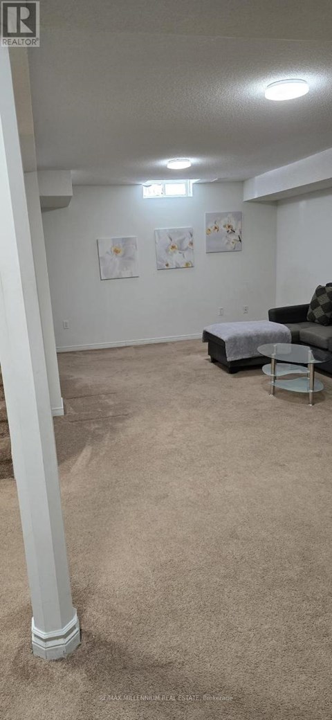 A living room with a couch and a bed.