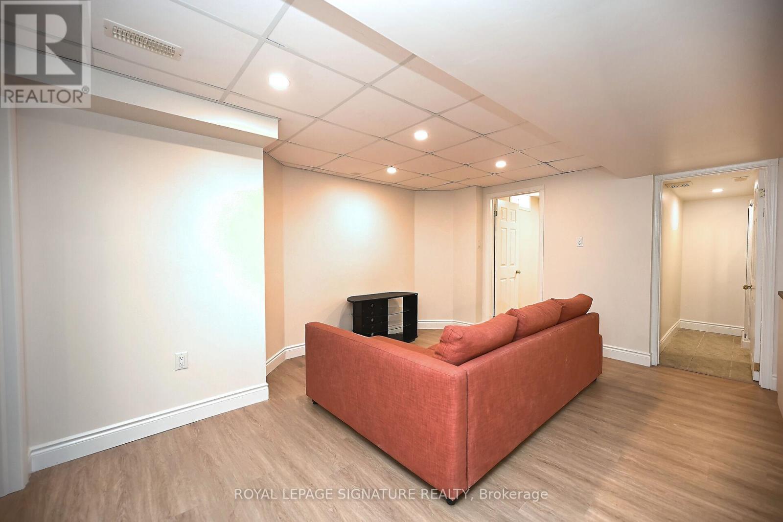 A living room with a red couch and a television.