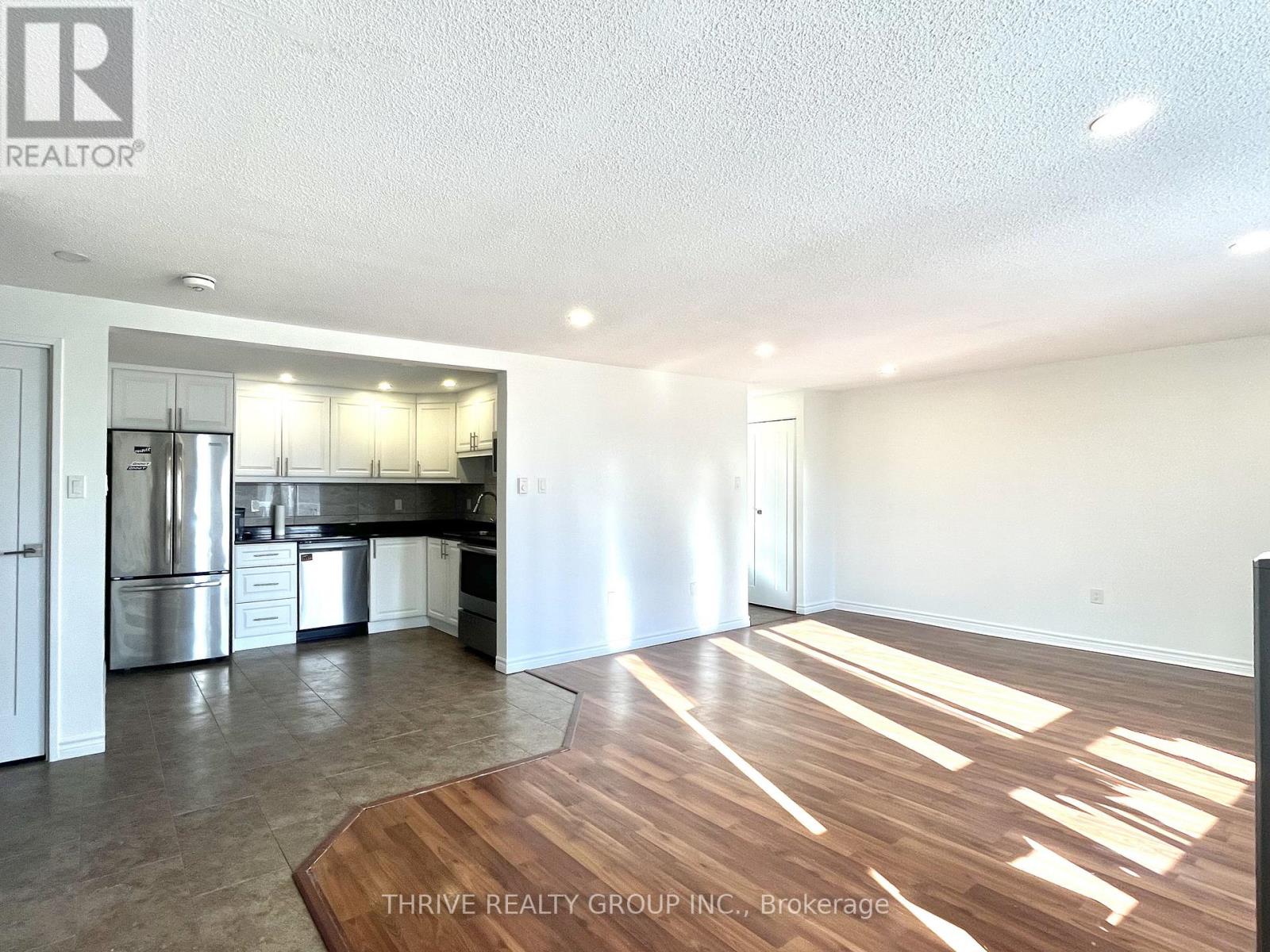A kitchen with white cabinets and stainless steel appliances is shown.