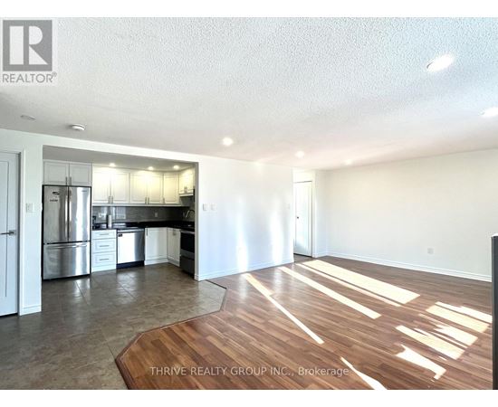 A kitchen with white cabinets and stainless steel appliances is shown.