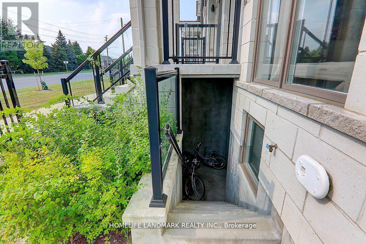 A bicycle is parked in a small alcove under a staircase.