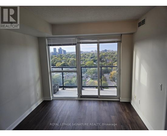 A room with a view of the city through large windows.