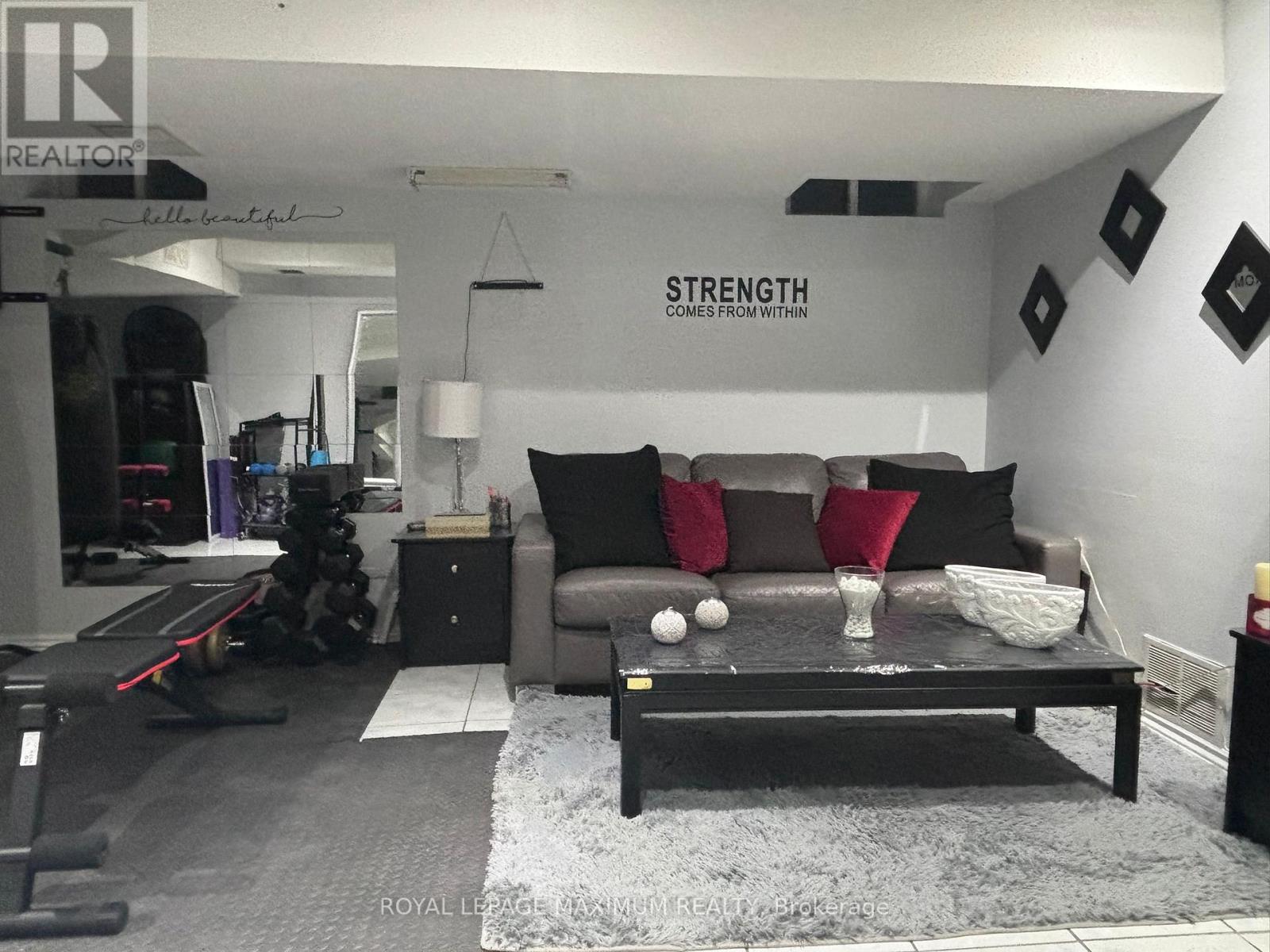 A living room with a grey couch and a black coffee table.