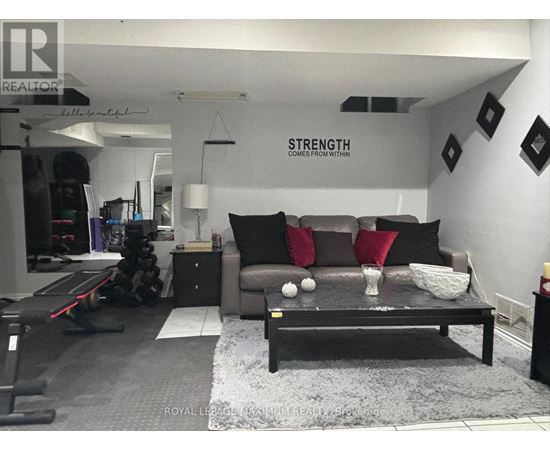 A living room with a grey couch and a black coffee table.