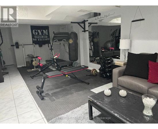 A gym room with a treadmill, weights, and exercise equipment.