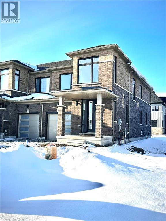 A large house with a snow covered ground in front.