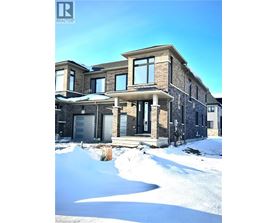 A large house with a snow covered ground in front.