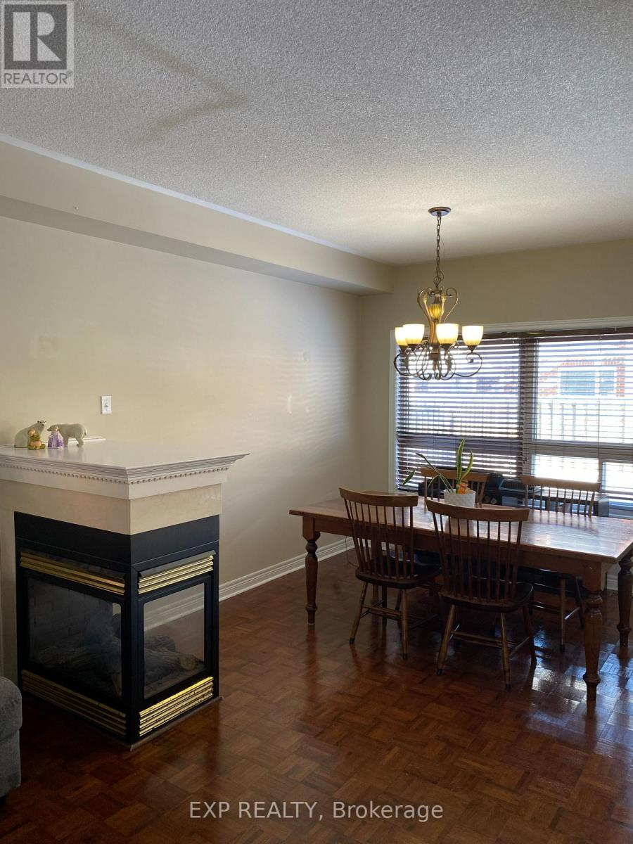 A dining room with a fireplace and a table set for four.