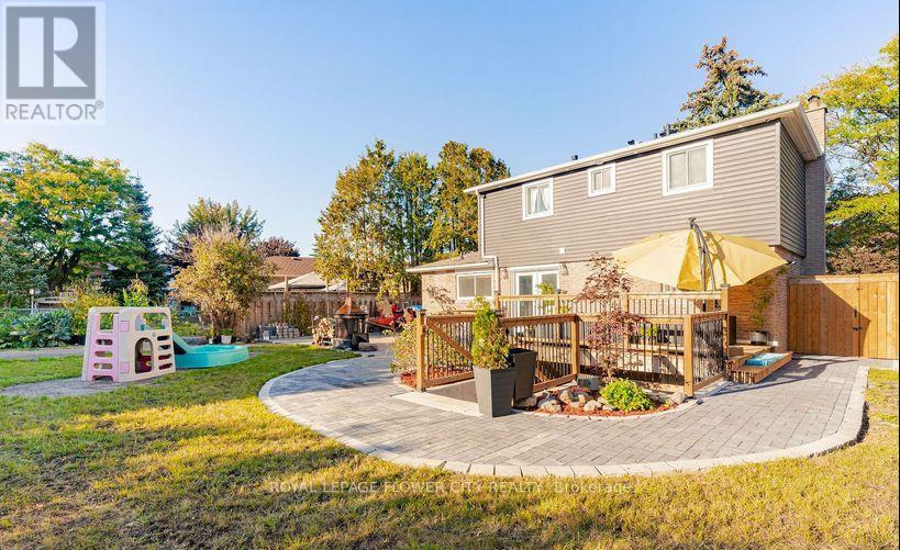 A house with a backyard that has a playground and a patio.